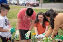 Students work in the Midway Park Community Garden.