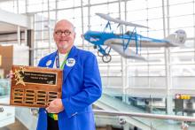 Tim Bailey, SEA's volunteer of the year, holding his award