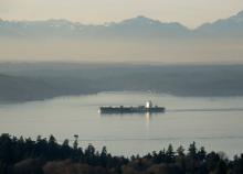 Cargo ship on Elliott Bay with beautiful mountains in the background