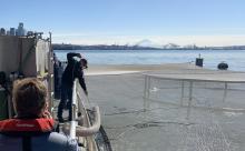 Stocking a fish rearing pen on board the tribal vessel Challacum