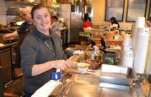 Beechers Cheese employee scooping macaroni and cheese