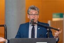 Commissioner Fred Felleman speaking behind a podium