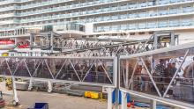 Passengers board a cruise ship at the Bell Street Cruise Terminal in Seattle, September 2018