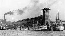 Vessels of the Mosquito Fleet, primary conveyances for travel throughout the Puget Sound Region in the 1180-1890s, take every foot of space at Colman Dock, Seattle, ca 1909.