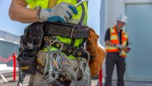 Represented employee with equipment and tools on his tool belt