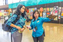 Pathfinder at SEA Airport helping a traveling navigate the airport