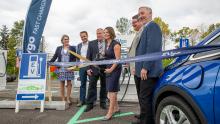 Commissioner Courtney Gregoire is joined by leaders from WSDOT, EVgo, and Forth in a ribbon cutting ceremony for new EV charging stations at Sea-Tac Airport