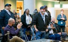 Members of the AV Maintenance Field Crew Garage Team stand to be recognized by their peers