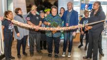 Owner Sam Choy, his staff, and SEA Leader Dawn Hunter cut the "lei" for a grand opening  of Poke to the Max at SEA, Dec. 13, 2019