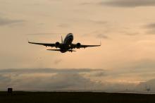 Ascending airplane shortly after takeoff silhoutted on a pink sky, SEA Airport, Nov. 2008