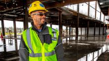 Jeffrey Brown touring the International Arrivals Hall construction site at SEA Airport in hardhat and visible vest, April 2018