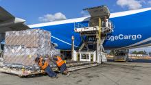 Air cargo workers unload a large pallet of cargo from an Airbridge Cargo plane at SEA Airport, Sept. 2016