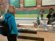 Customer and employees of Evergreen's at SEA Airport wear a face coverings during the COVID-19 pandemic, May 2020mast