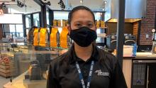 SSP Dining employee at SEA Airport poses with face covering during COVID-19 pandemic, June, 2020 