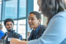 Zoomed in image of three participants talking during a round-table discussion.