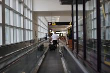 An Airport Employee on the moving walkways in A Gates
