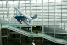 Vintage airplane suspended from the ceiling at SEA Airport