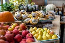 Beautiful produce on a table with pears, squash, and apples