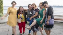 Diverse group of women share a laugh as they pose for the photo outside of the Port of Seattle waterfront offices, Aug. 2019