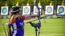Gabi participating in an archery competition.