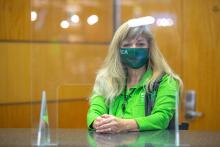 A pathfinder in a mask at the information desk