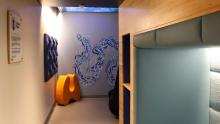 The inside of the sensory room with seating nook, furniture, and artwork
