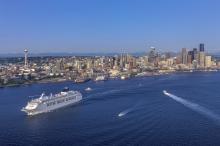 Cruise ship leaving the Port of Seattle with the skyline in the background.