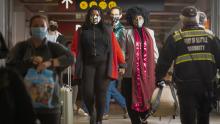 Masked Passengers Walking in the Terminal at SEA