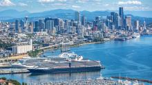 three cruise ships visible from an aerial shot just west of Terminal 91 with sweeping view of Elliott Bay on a clear day Seattle 2017