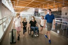 A family walks through SEA Airport