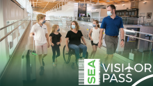 A family in masks at the airport with the SEA Visitor Pass Logo