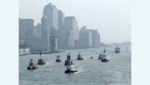 Tugboats and other craft rush to assist evacuation of people from lower Manhattan on Sept 11 2001