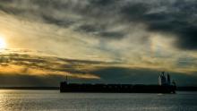 Container ship moored in Seattle with sunset in the background