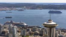 Top of the Space Needle with ferries and cruise ships in Elliott Bay Seattle. July 2021