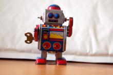 Red tin vintage toy robot with wind up key