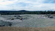 Cedar Hills Landfill with heavy equipment excavating within the open area
