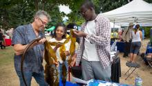 A young man and woman interact with Commissioner Felleman at the Duwamish River Festival