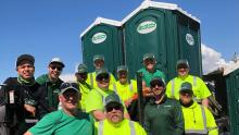 Green Latrine staff poses in front of green latrines.
