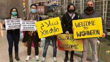 Ghulam Mohmand and Mina Le, along with other members of Viets for Afghans, wait at the airport to pick up their sponsor refugee family.