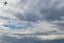 Plane in the cloudy sky