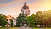 Washington state capitol building against a colorful sunset sky