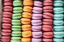 Five rows of colorful macarons, French cookies 