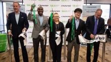 Executives cut a ribbon to mark the inaugural FinnAir flight from Helsinki  