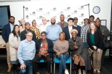 Group of 18 people smiling at Tabor 100.