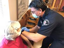 Captain Hendrickx administers vaccines to residents of local retirement community during the height of the pandemic 