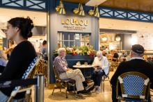 A photo of LouLou Market and Bar, travelers are sitting at tables and dining