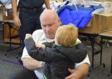 Assistant Chief Starkey helps the kids find that perfect fit