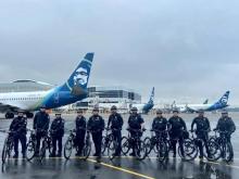 Police bike unit with their bikes, standing on the SEA airfield.