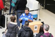 TSA agent checking IDs.