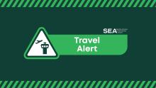 Graphic logo including the SEA Airport logo and the words Travel Alert